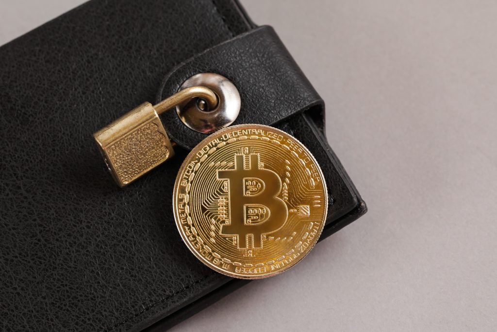 Concept Of Virtual Wallet And Bitcoins. Gold bitcoin and padlock. 