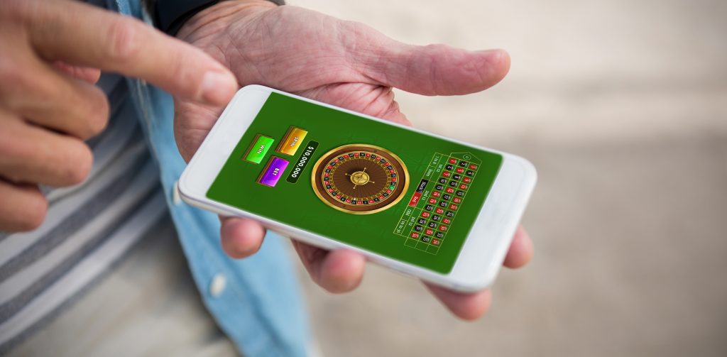 An online mobile casino game in the hand of a player, a roullet crypto game.