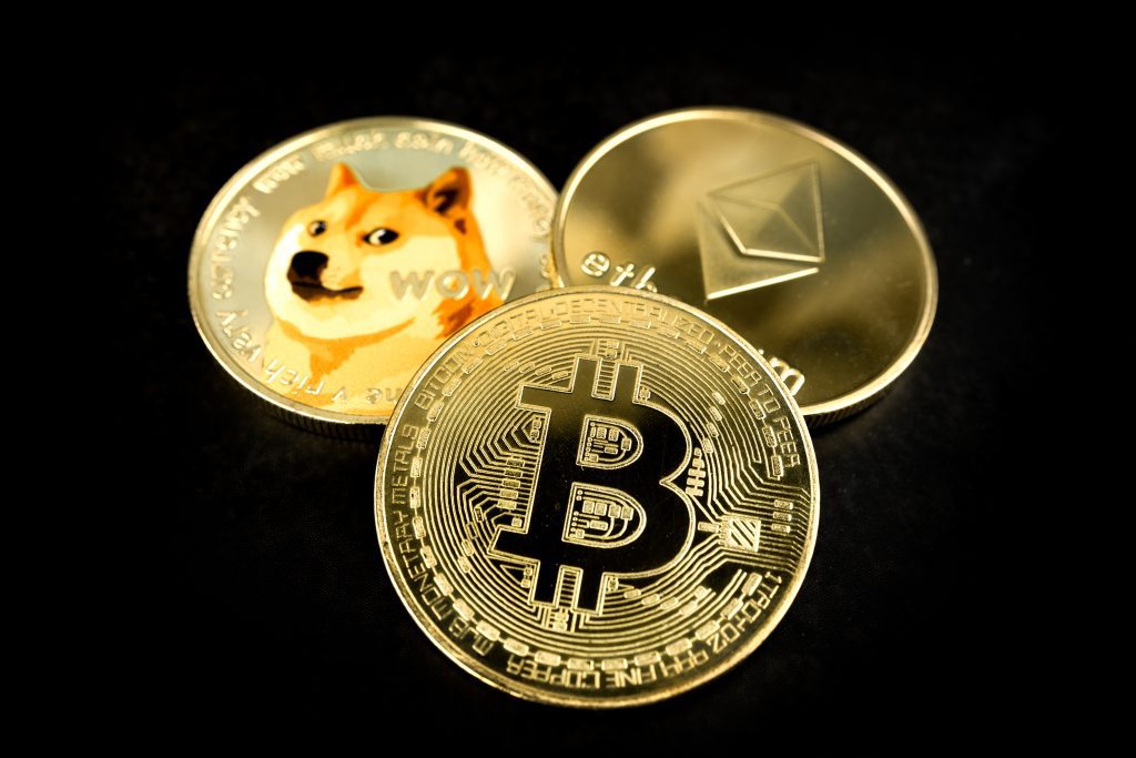 three coins bitcoin, ethereum, dogecoin on a black background. The concept of virtual money. Mining or blockchain technology. Business concept.