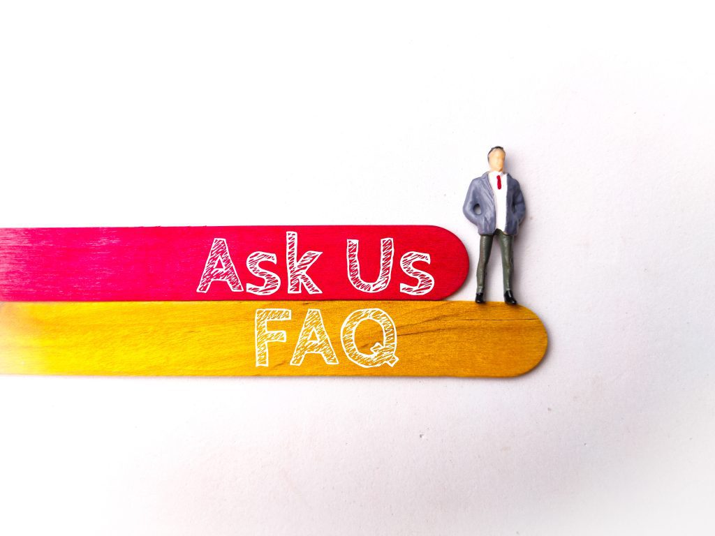 Top view miniature people and colored ice cream stick with text Ask Us FAQ on white background meaning for AMA session in Crypto