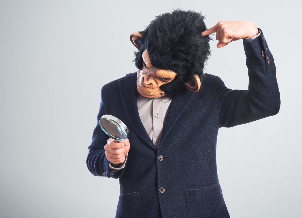 monkey man with magnifying glass apeing