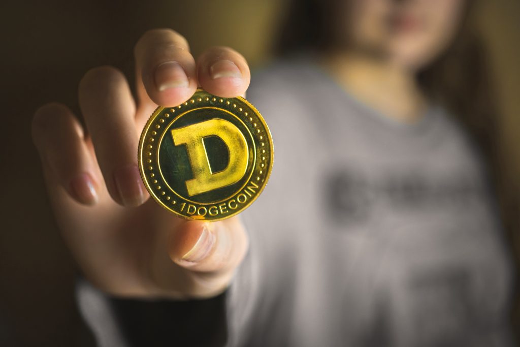 Woman hand with Dogecoin, cryptocurrency business background photo