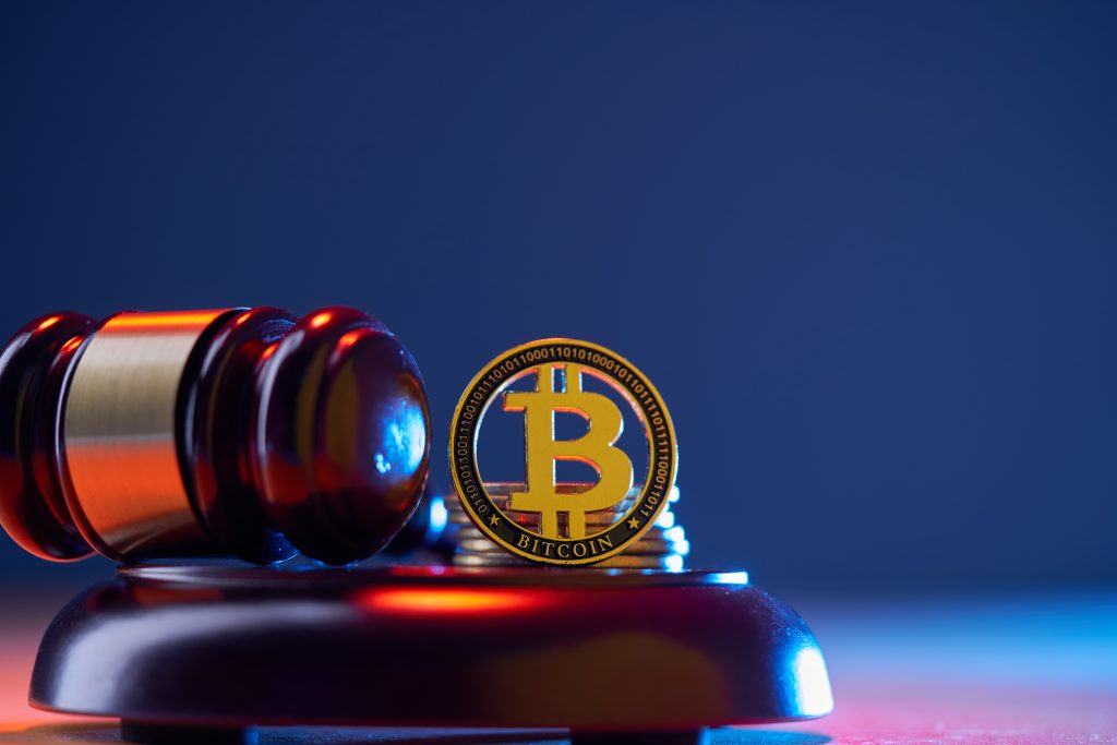 Bitcoin, the judge's gavel on blue background table. E-business, Finance. virtual currency.