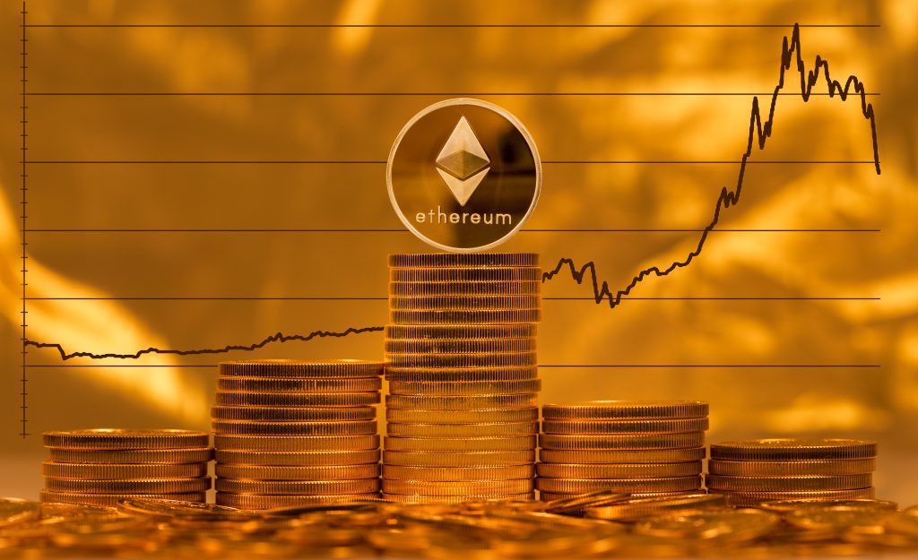 Single ethereum coin on stack of gold coins with graph of price change against US dollar in background gas fees