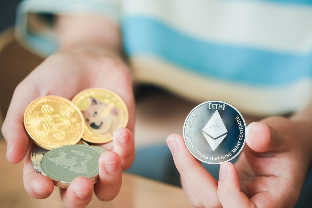 A woman's hand holding a ethereum coin, New concept crypto currency vs virtual coin is the future of digital currency online financial payments.