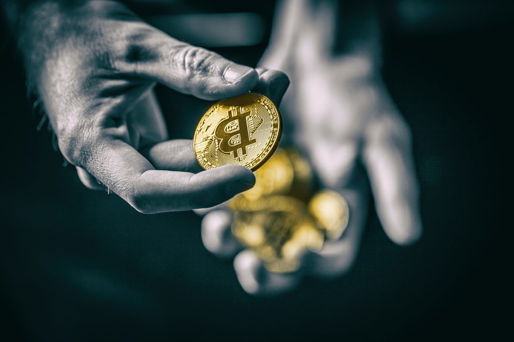 Man holding in hand symbol of crypto currency, selective focus. Representing an Initial Exchange Offerings IEO