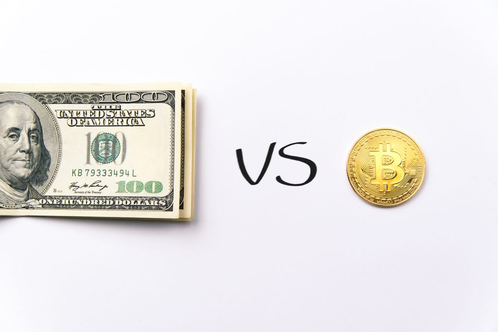 purpose of cryptocurrency. Choice bundle of hundred dollar banknotes bills and bitcoin gold coin. Exchange bitcoin for dollar. Bitcoin vs fiat money