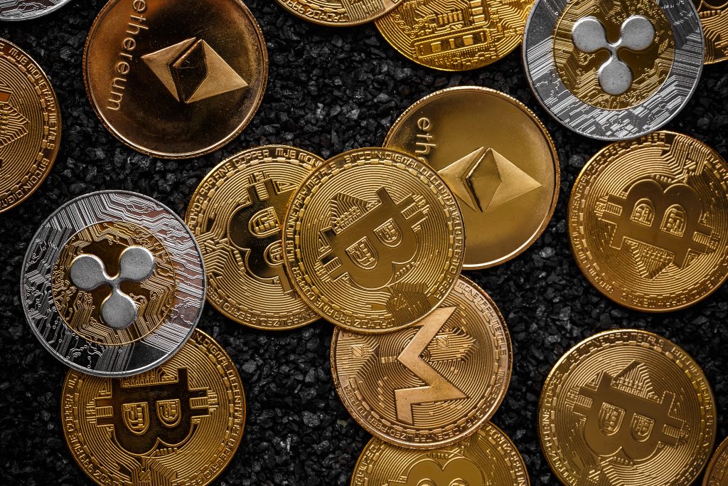 Set of cryptocurrencies with a golden bitcoin in the middle before comparing vs fiat money